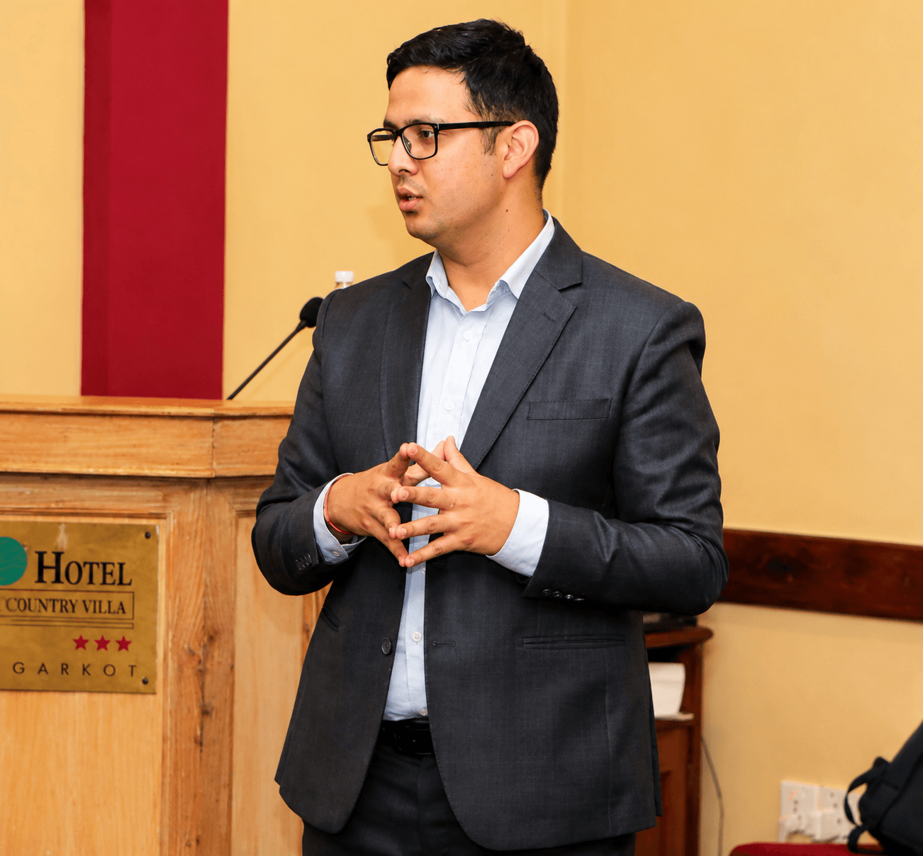 Bibek Bhandary sales training approach in Nepal at a podium during a business conference.